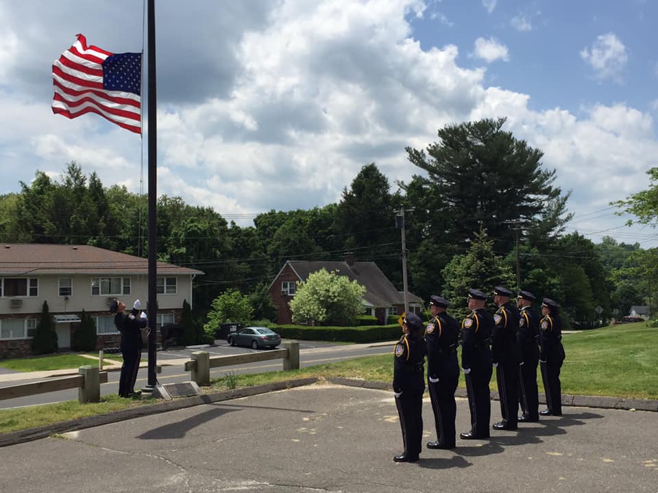 WPD Honor Guard lowering the Flag in front of the Watertown Police Department to half mast.
